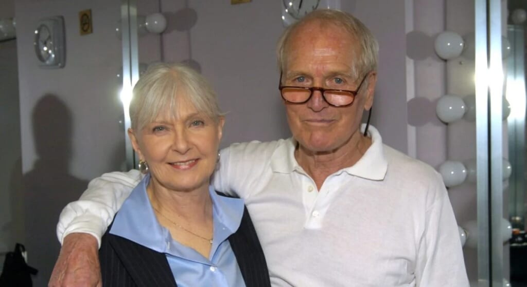 Paul Newman Joanne Woodward with their arms around eachother.
