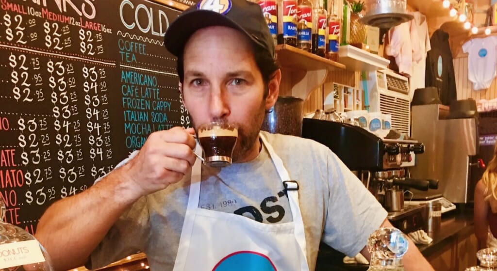 Paul Rudd drinking a cappuccino at his and wife Julie Yaegar's candy shop.